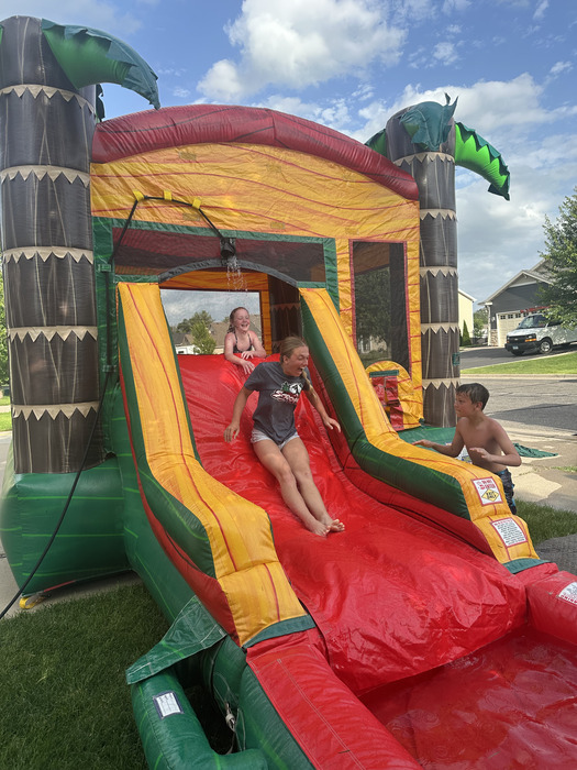 kids playing on a inflatable bounce house